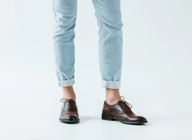 Oxford shoes and blue jeans