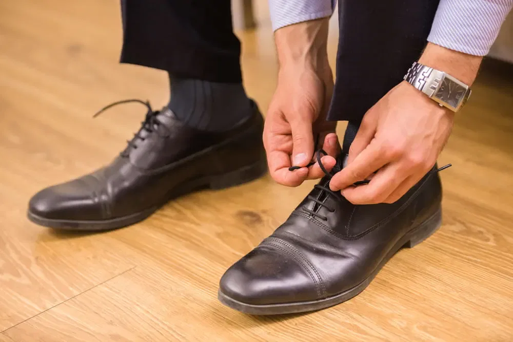 textured grey socks with black shoes