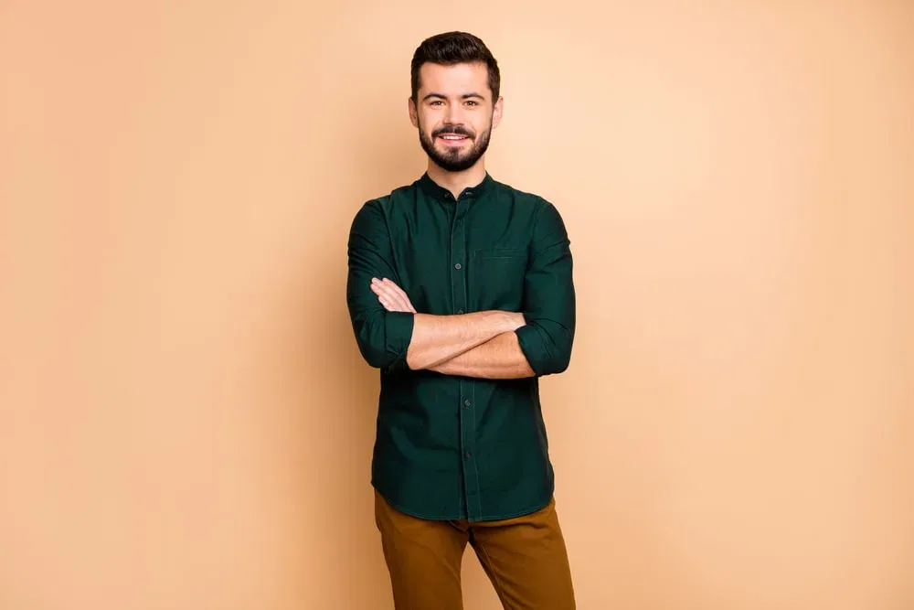 dark green shirt with brown pants