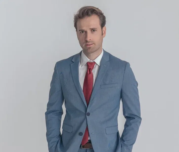 light blue suit with red tie 