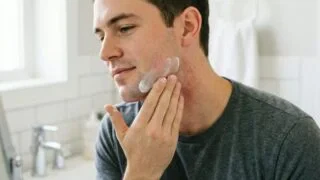 Man applying aftershave balm to prevent stubble rash