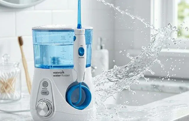 Waterpik water flosser on bathroom countertop