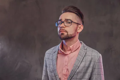 man in pink shirt and grey blazer
